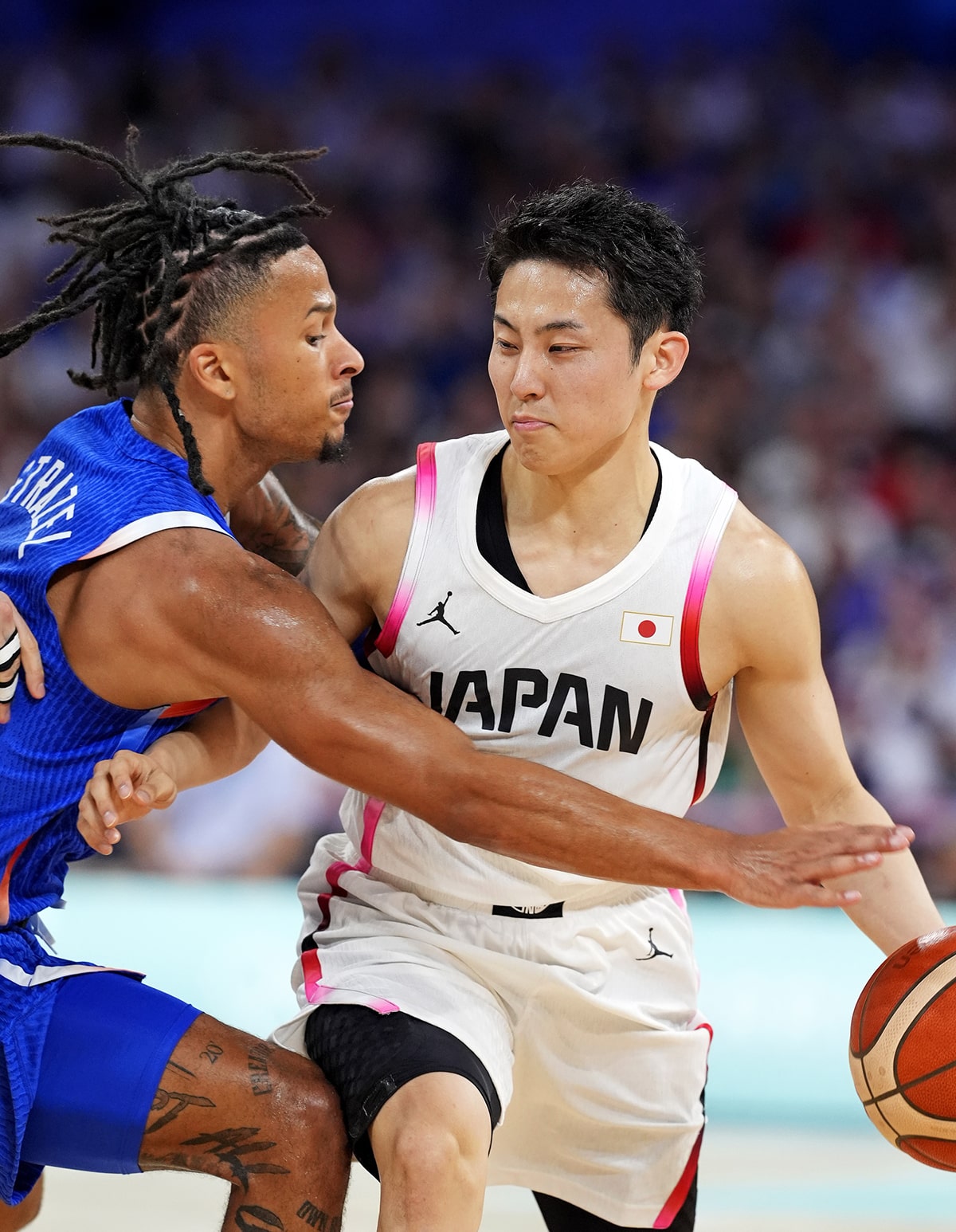 Japan point guard Yuki Kawamura (5) handles the ball against France point guard Matthew Strazel (85) in men’s basketball group B play during the Paris 2024 Olympic Summer Games at Stade Pierre-Mauroy.