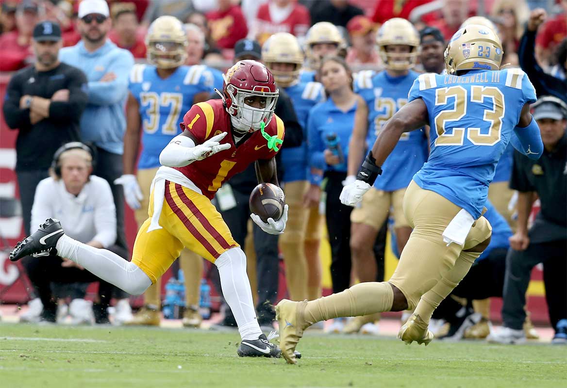 USC Trojans wide receiver Zachariah Branch (1) runs against UCLA Bruins defensive back Kenny Churchwell III (23) during the first quarter at United Airlines Field at Los Angeles Memorial Coliseum.