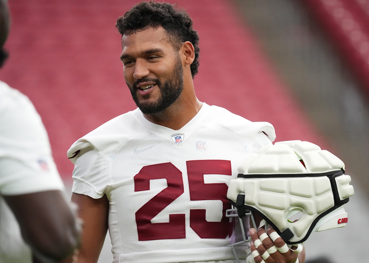 Arizona Cardinals linebacker Zaven Collins (25) chats with his teammates during training camp at State Farm Stadium in Glendale on July 25, 2024.