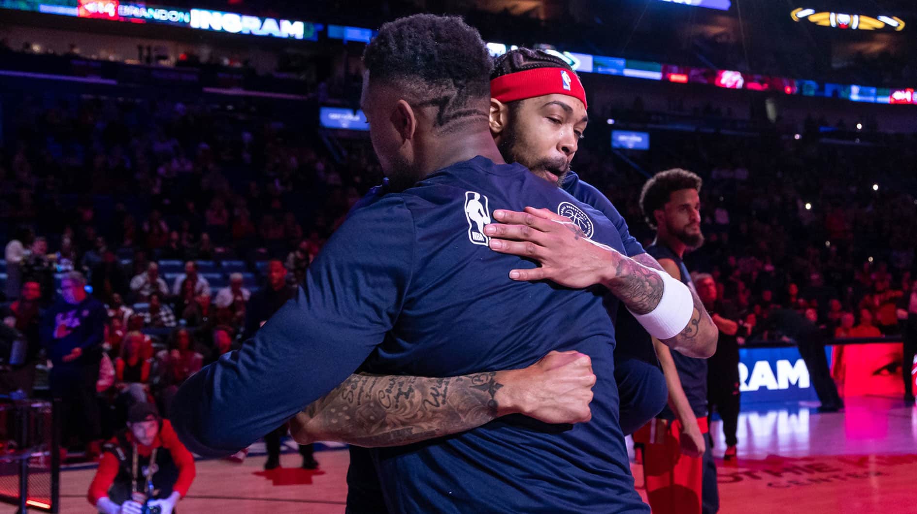 New Orleans Pelicans forward Brandon Ingram (14) hugs forward Zion Williamson (1) as he is announced to the fans to start the game against the Washington Wizards during the first half at Smoothie King Center. 