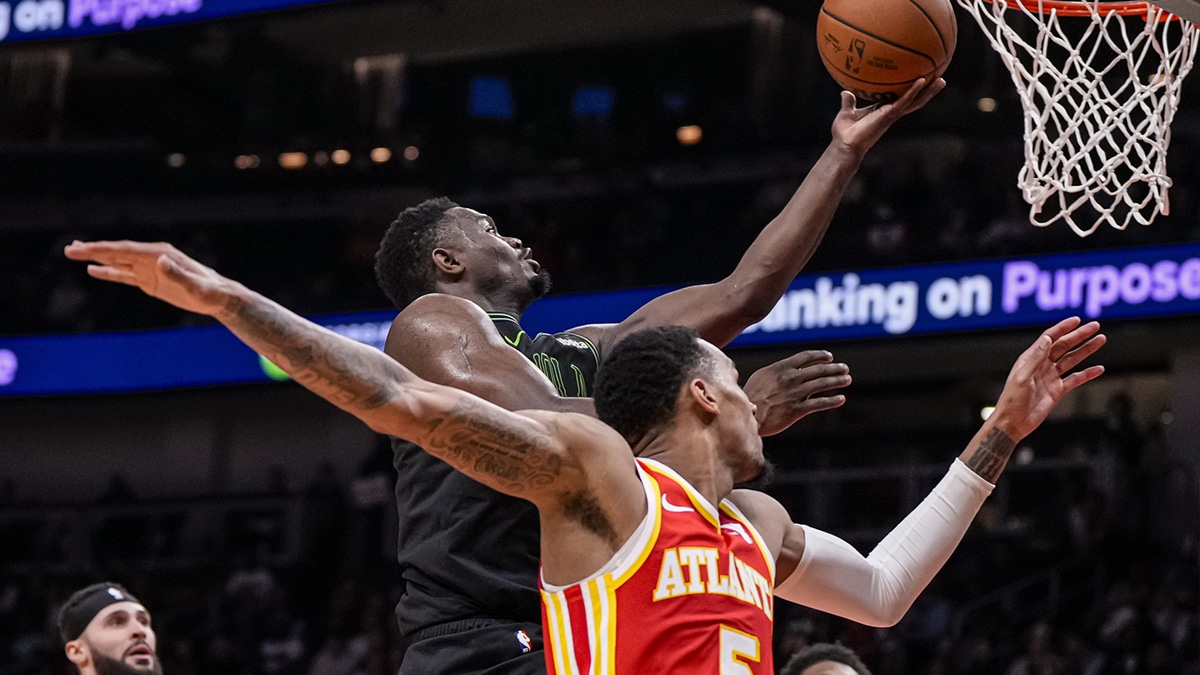 New Orleans Pelicans forward Zion Williamson (1) drives to the basket behind Atlanta Hawks guard Dejounte Murray (5) during the second half at State Farm Arena.