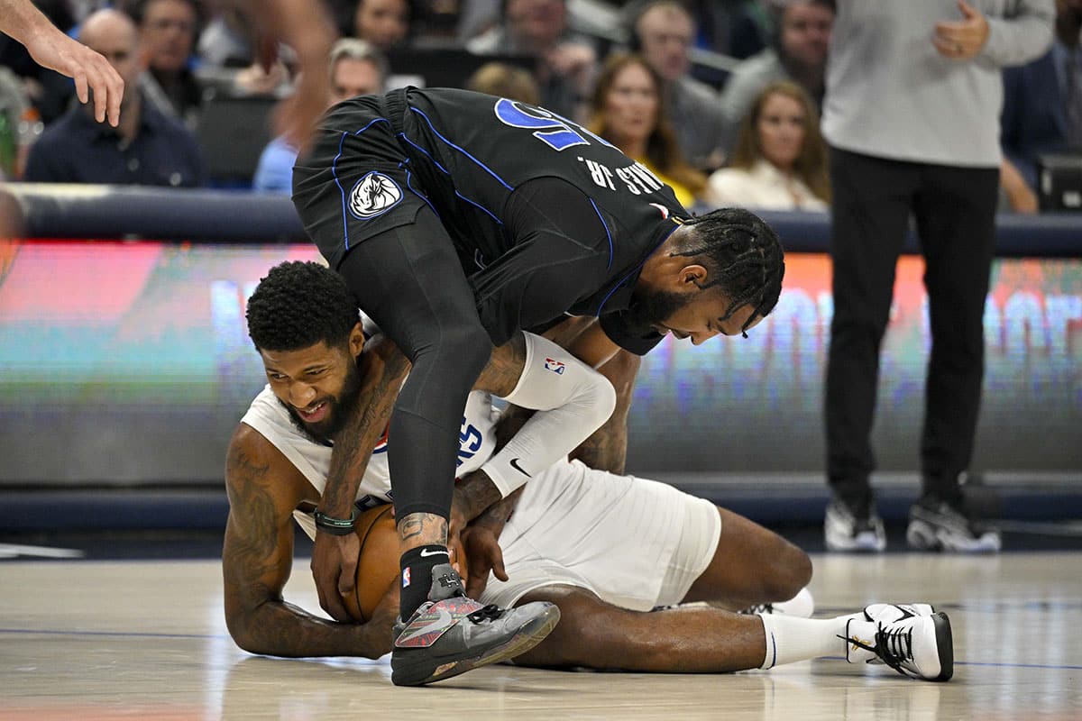 LA Clippers forward Paul George (13) and Dallas Mavericks forward Derrick Jones Jr. (55) battle for control of the loose ball during the first quarter during game six of the first round for the 2024 NBA playoffs at American Airlines Center. 