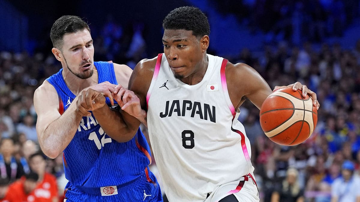 Japan small forward Rui Hachimura (8) drives to the basket against France shooting guard Nando de Colo (12) in men’s basketball group B play during the Paris 2024 Olympic Summer Games at Stade Pierre-Mauroy. 
