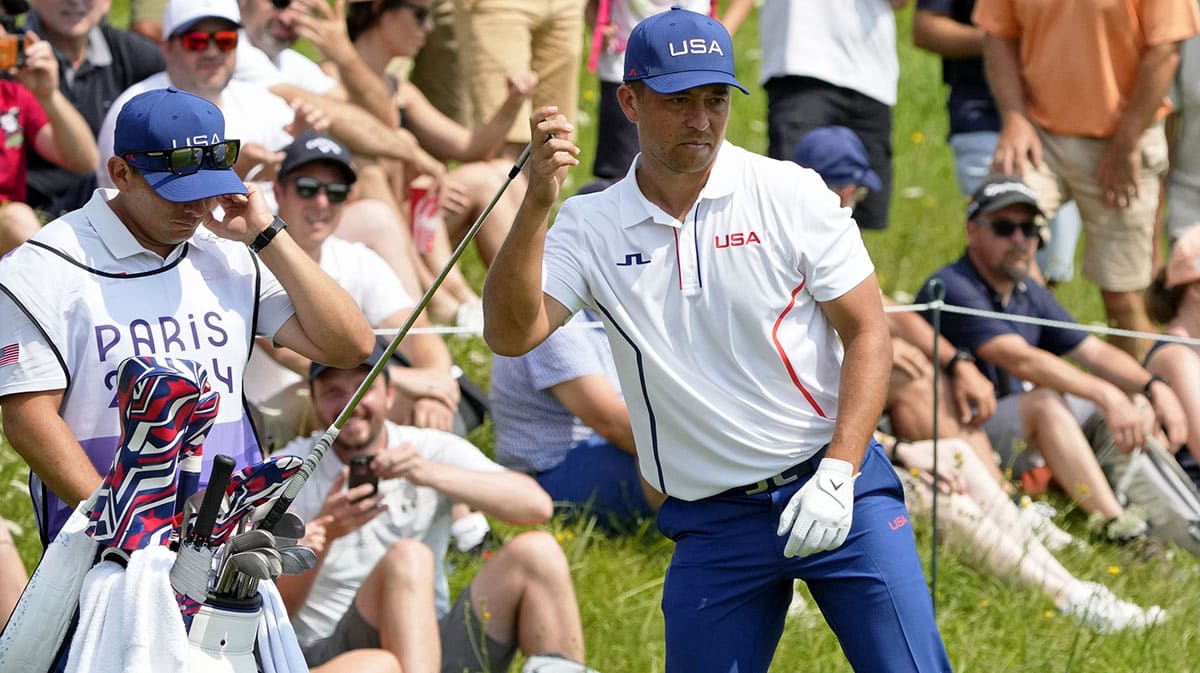 Xander Schauffele of Team United States grabs a club on the 12th green in round two of menís stroke play during the Paris 2024 Olympic Summer Games at Le Golf National