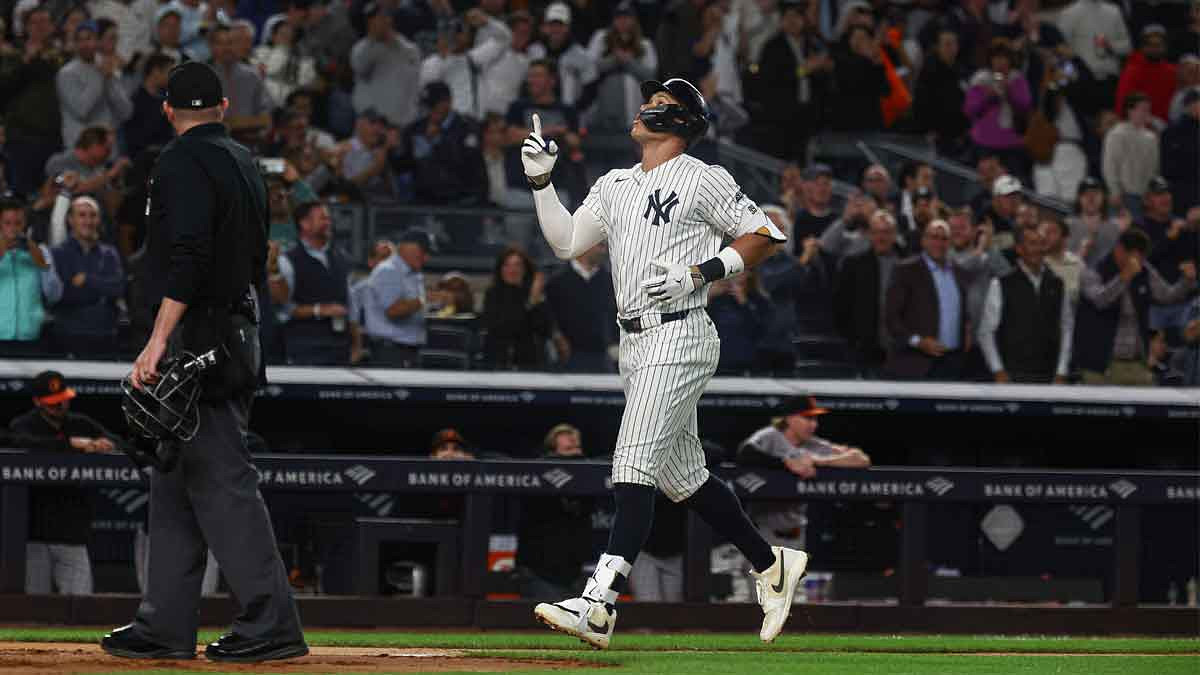 New York Yankees center fielder Aaron Judge (99) celebrates by running to base after hitting a solo home run in the fourth inning against the Baltimore Orioles at Yankee Stadium.