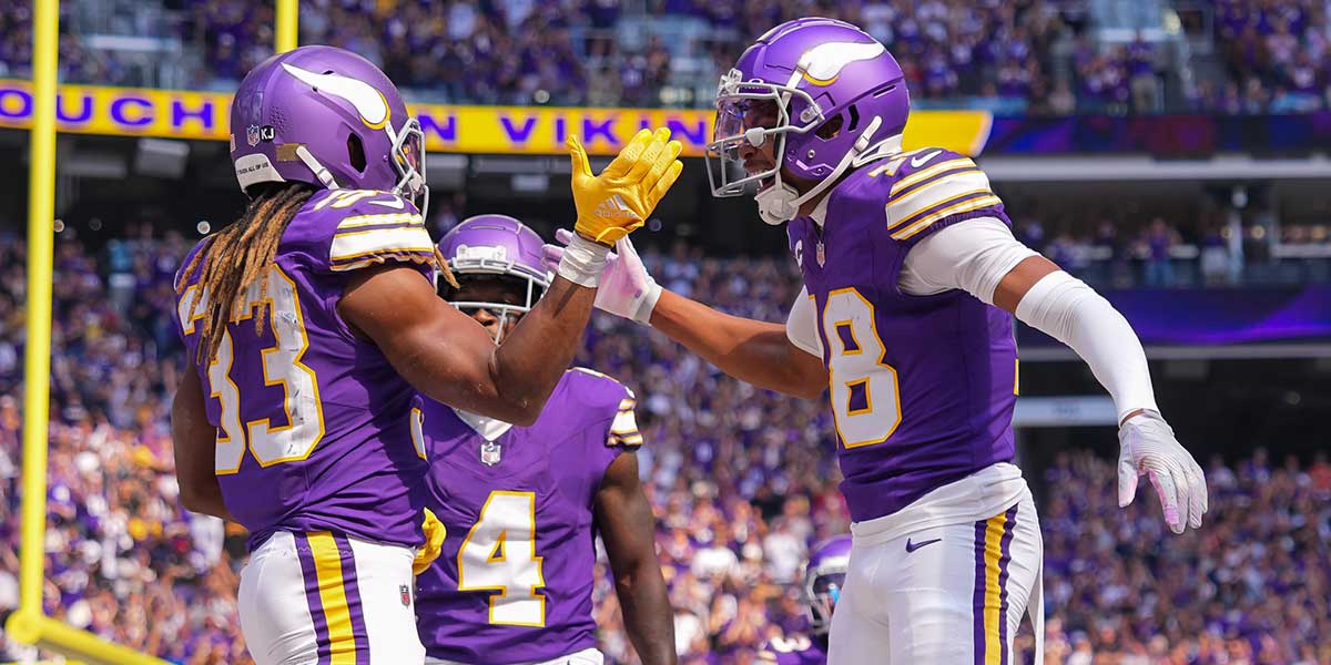 Minnesota Vikings running back Aaron Jones (33) celebrates his touchdown with wide receiver Justin Jefferson (18) against the Houston Texans in the first quarter at U.S. Bank Stadium.