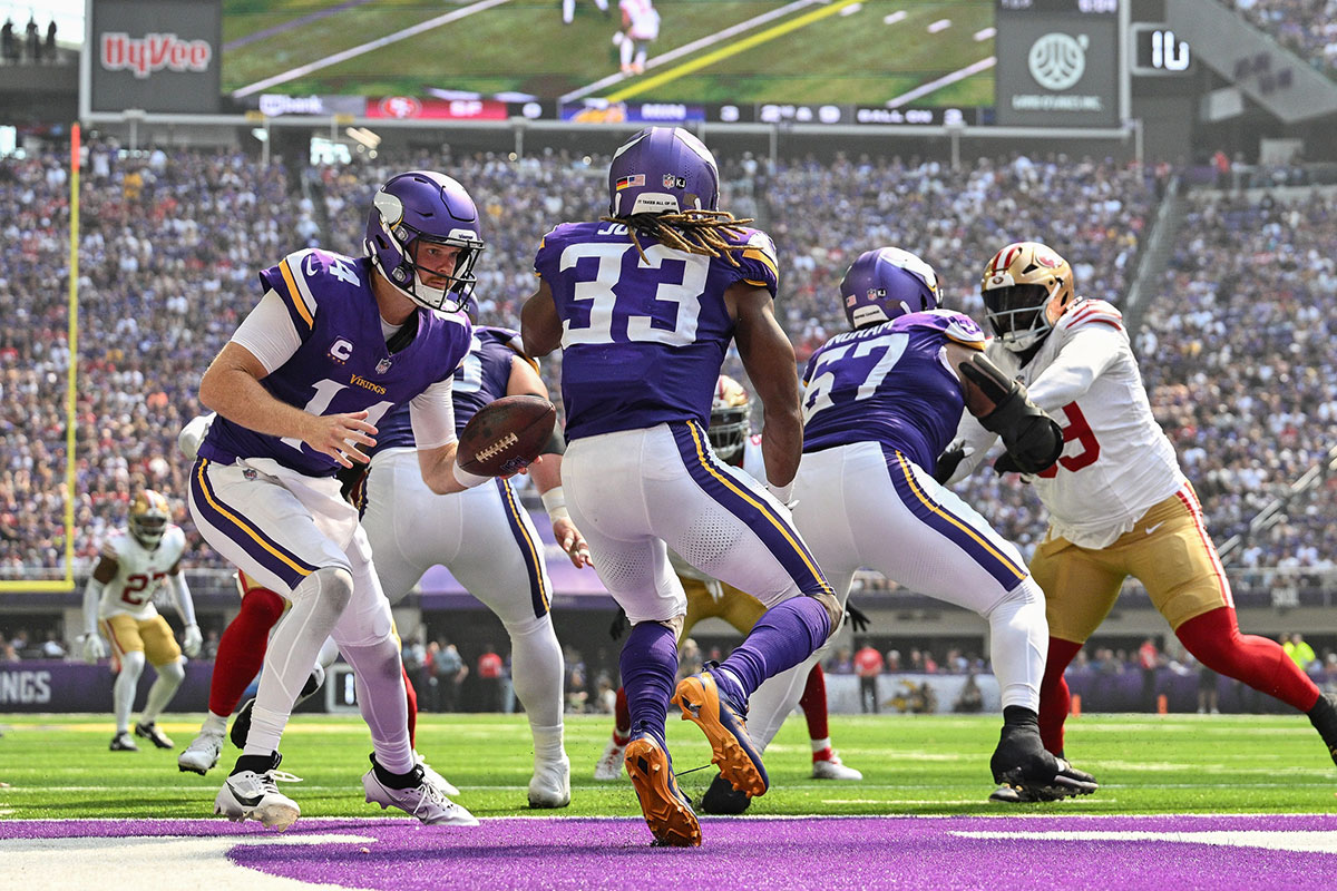 Minneapolis, Minnesota, USA; Minnesota Vikings quarterback Sam Darnold (14) and running back Aaron Jones (33) in action against the San Francisco 49ers during the game at U.S. Bank Stadium