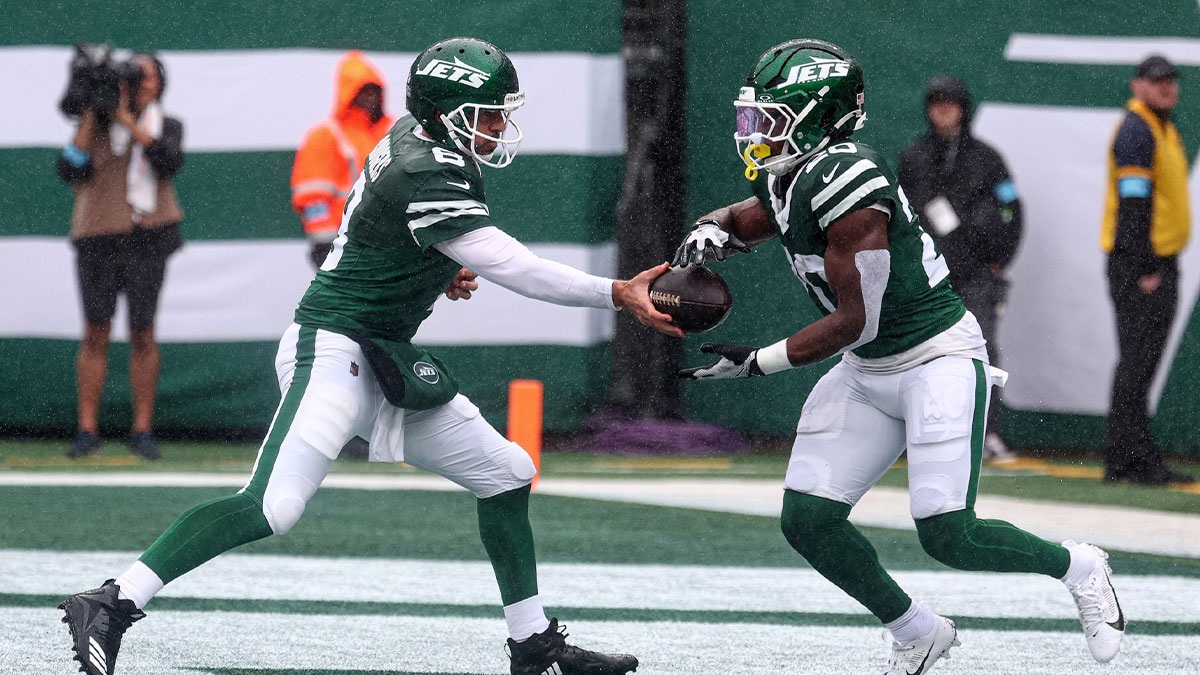 New York Jets quarterback Aaron Rodgers (8) hands off to running back Breece Hall (20) during the first half against the Denver Broncos at MetLife Stadium.
