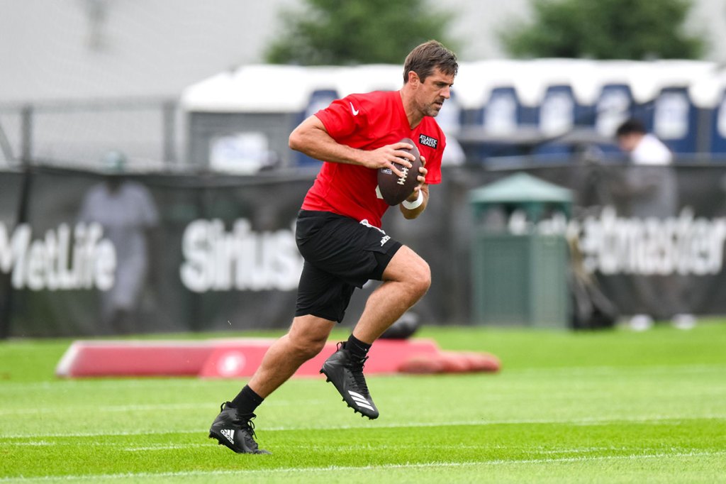 New York Jets quarterback Aaron Rodgers (8) participates in a drill during training camp at Atlantic Health Jets Training Center.