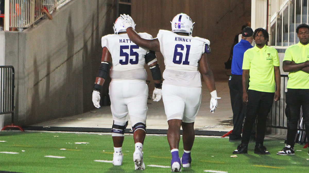 Abilene Christian Wildcats offensive guard Alan Hatten and offensive tackle Dylan Kinney (61) leave the field after the overtime loss to the Texas Tech Red Raiders at Jones AT&T Stadium and Cody Campbell Field.