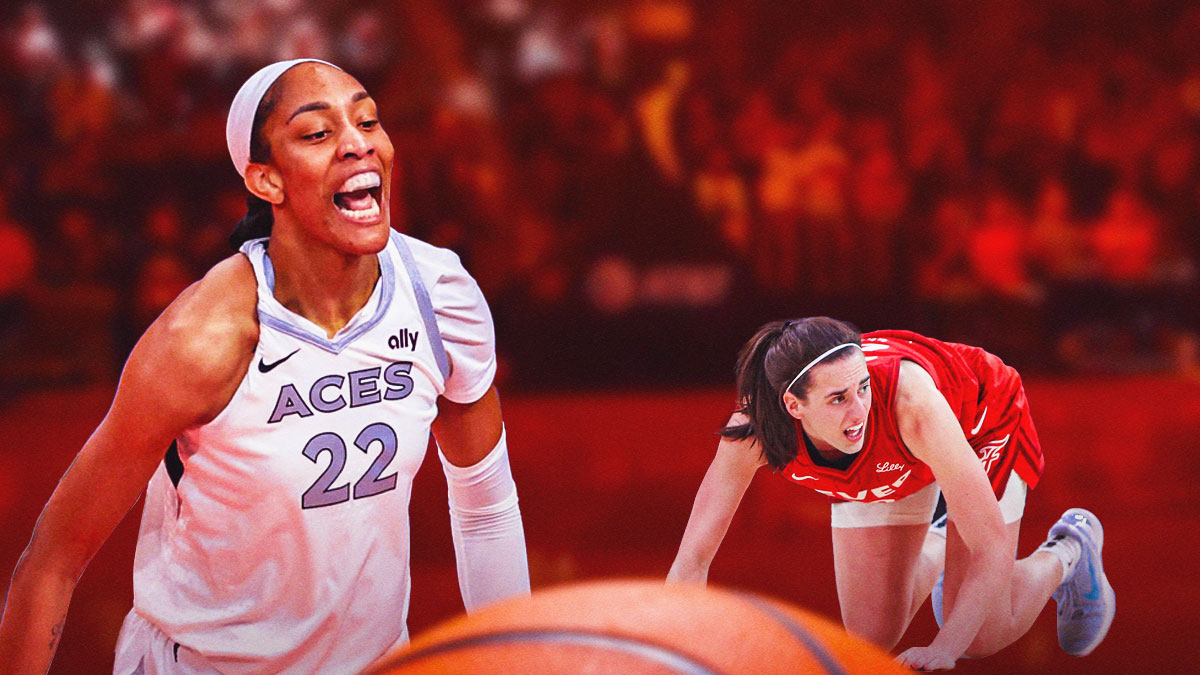 A'ja Wilson yelling or celebrating next to Caitlin Clark on the ground