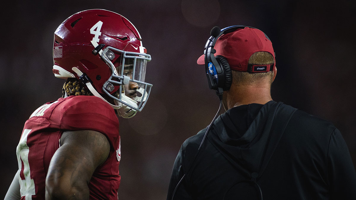Alabama Crimson Tide quarterback Jalen Milroe (4) talks with head coach Kalen DeBoer during a timeout in the third quarter against the Georgia Bulldogs at Bryant-Denny Stadium.