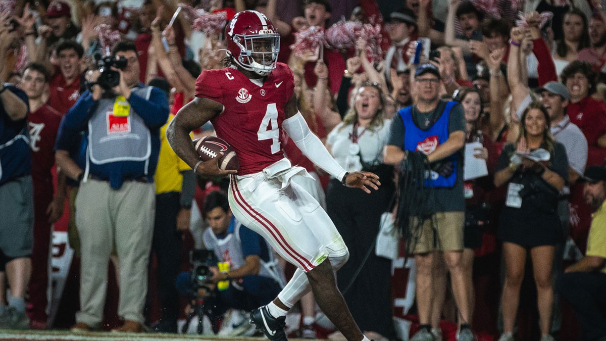Alabama Crimson Tide quarterback Jalen Milroe (4) scores a touchdown against the Georgia Bulldogs during the first quarter at Bryant-Denny Stadium