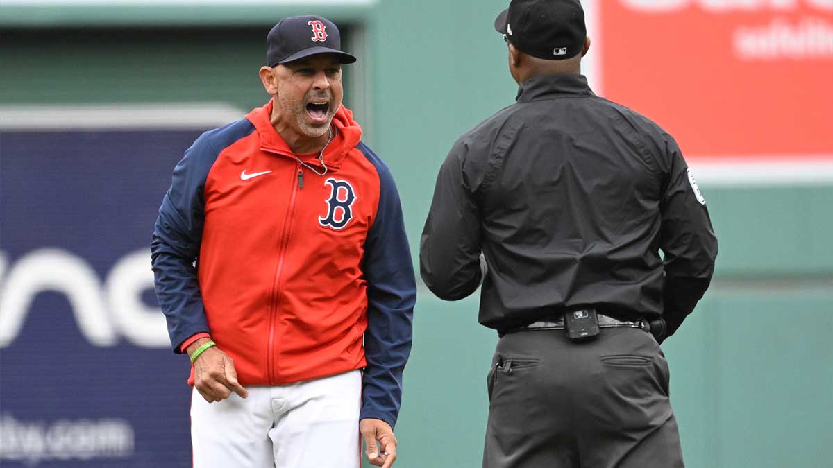 Sep 22, 2024; Boston, Massachusetts, USA; Boston Red Sox manager Alex Cora (13) argues his case to umpire Alan Porter (64) during the first inning against the Minnesota Twins at Fenway Park. 