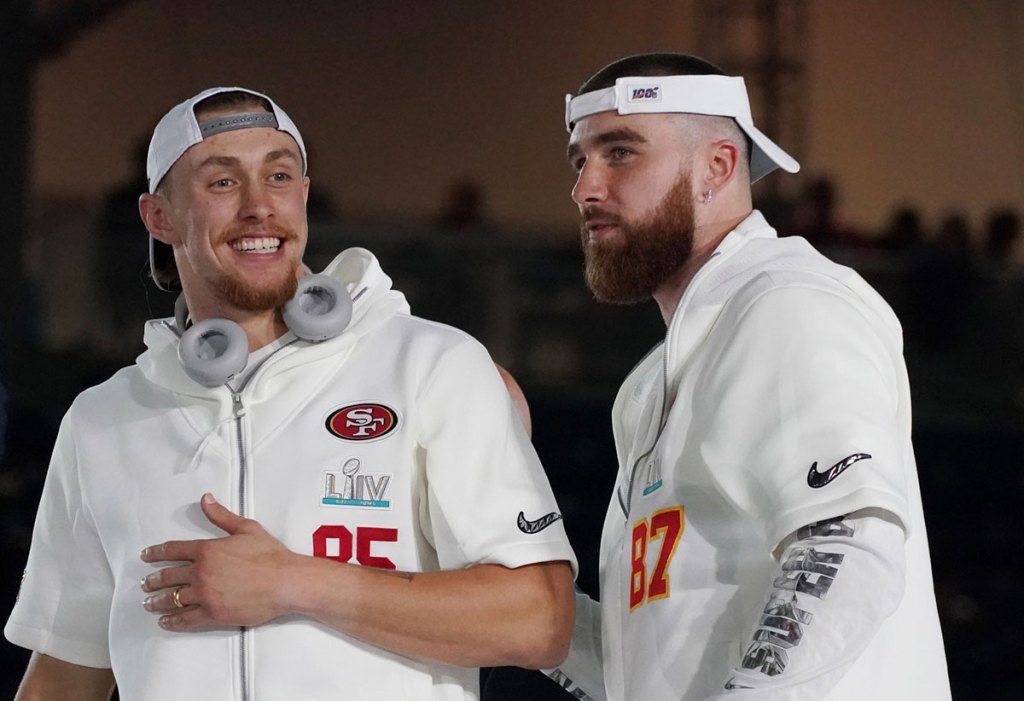 san francisco 49ers tight end george kittle (85) greets kansas city chiefs tight end travis kelce (87) during super bowl liv opening night at marlins park.