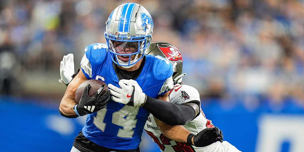 Detroit Lions wide receiver Amon-Ra St. Brown (14) makes a catch against Tampa Bay Buccaneers safety Tykee Smith (23) during the second half at Ford Field.