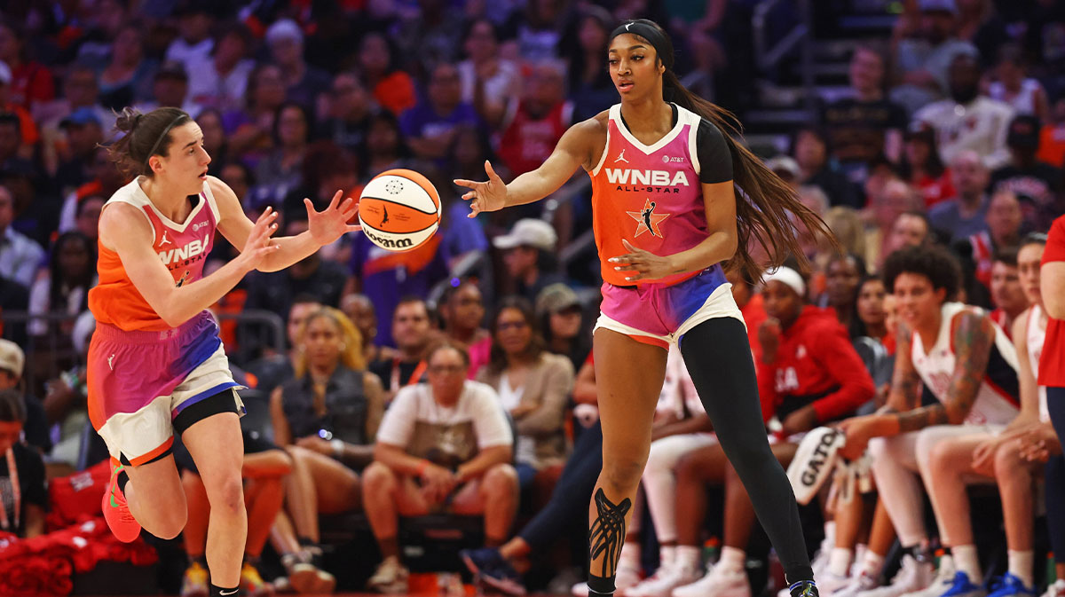 Team WNBA forward Angel Reese (5) passes the ball to Team WNBA guard Caitlin Clark (22) during the first half against the USA Women's National Team at Footprint Center.