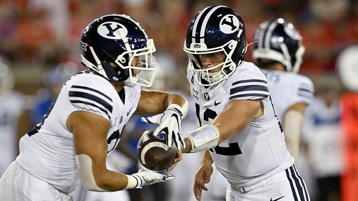 Brigham Young Cougars running back LJ Martin (27) and quarterback Jake Retzlaff (12) in action during the game between the Southern Methodist Mustangs and the Brigham Young Cougars at Gerald J. Ford Stadium.