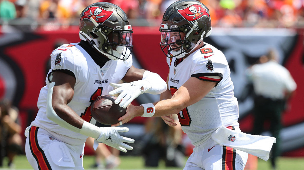 Tampa Bay Buccaneers quarterback Baker Mayfield (6) hands the ball off to running back Rachaad White (1) during the first quarter against the Denver Broncos at Raymond James Stadium.