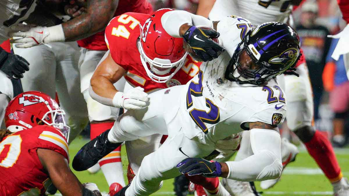 Baltimore Ravens running back Derrick Henry (22) scores a touchdown as Kansas City Chiefs linebacker Leo Chenal (54) attempts the tackle during the first half at GEHA Field at Arrowhead Stadium. 