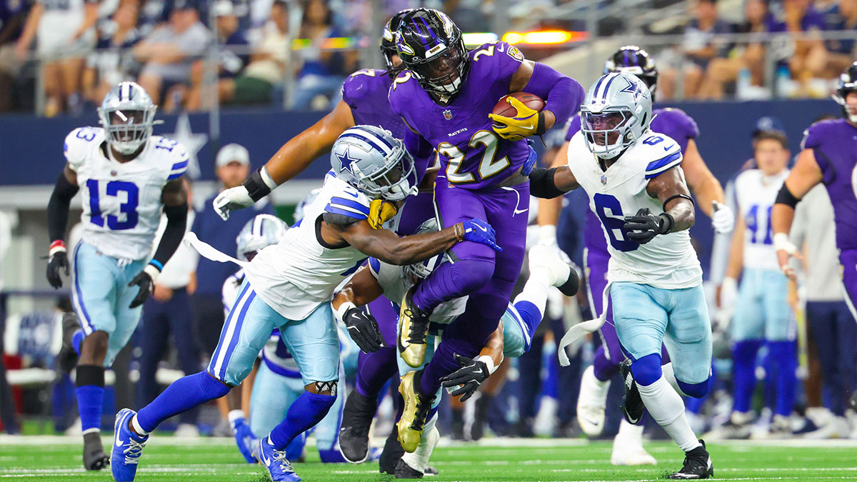 Baltimore Ravens running back Derrick Henry (22) runs during the first half as Dallas Cowboys safety Donovan Wilson (6) and Dallas Cowboys cornerback Jourdan Lewis (2) defend at AT&T Stadium.