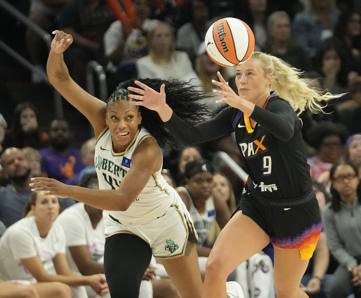 Phoenix Mercury guard Sophie Cunningham (9) grabs a loose ball away from New York Liberty forward Betnijah Laney-Hamilton (44) during the first quarter at Footprint Center on Aug. 26, 2024, in Phoenix.