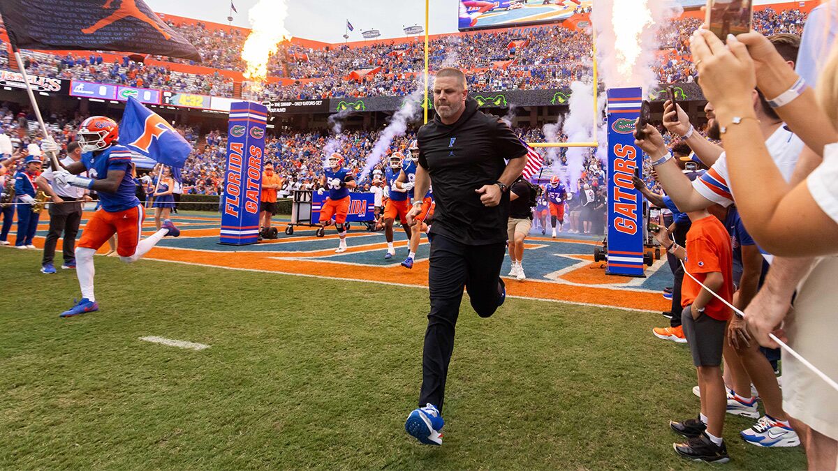 Florida Gators head coach Billy Napier runs onto the field before the start of the game at Ben Hill Griffin Stadium