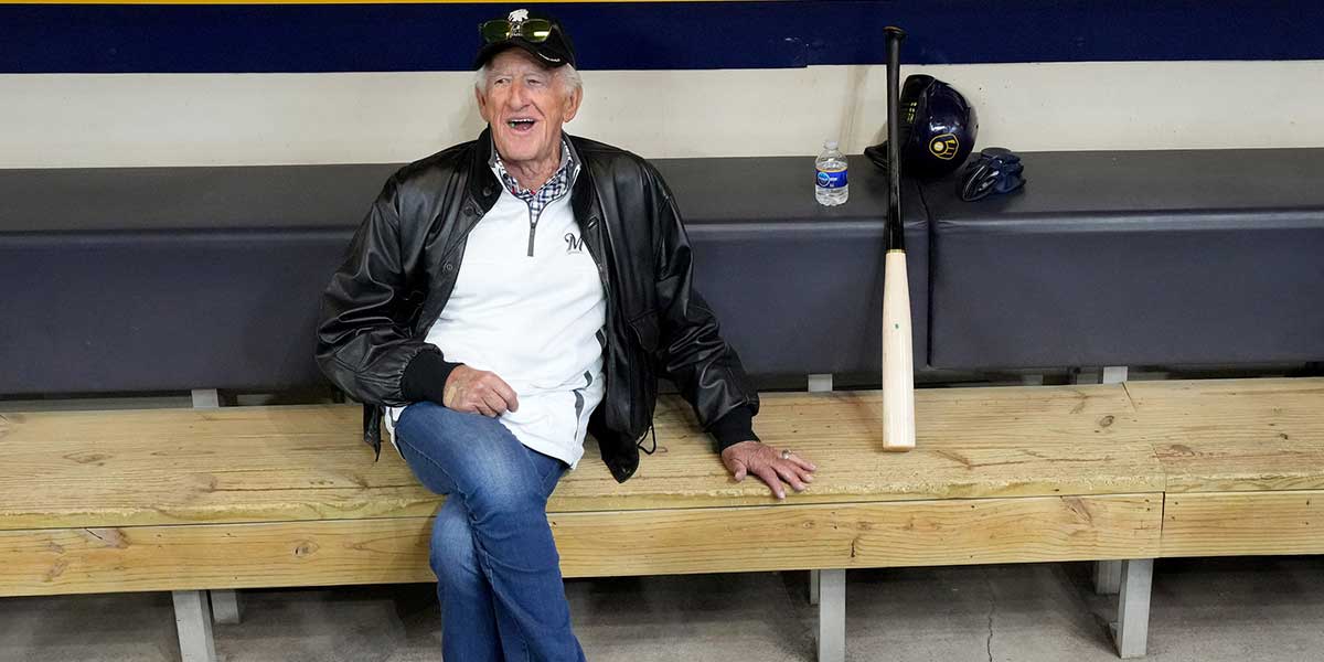 Milwaukee Brewers play-by-play announcer Bob Uecker sits in the dugout while players workout at American Family Field in Milwaukee on April 6, 2022.