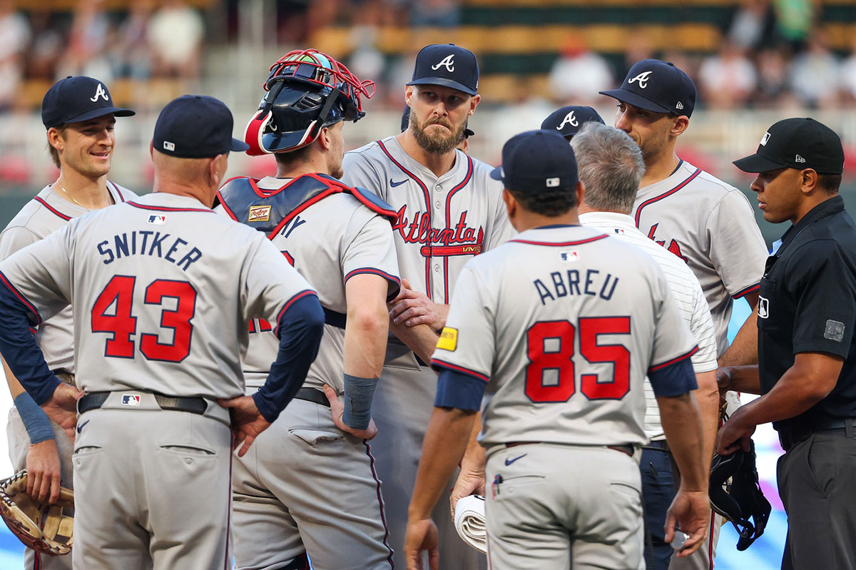 Atlanta Braves starting pitcher Chris Sale (51) is looked at by training staff after taking a ground ball to the arm during the third inning against the Minnesota Twins at Target Field.