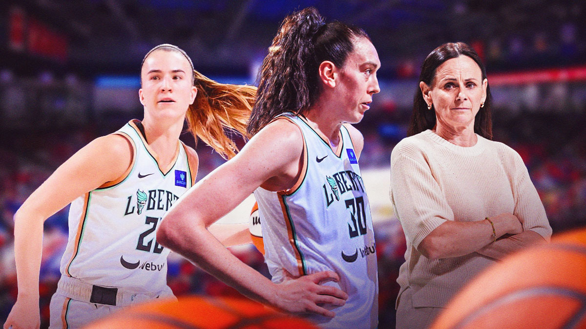 Breanna Stewart (Liberty), serious expression, hands on hips. Sabrina Ionescu (Liberty), Sandy Brondello (Liberty coach) behind, Barclays Center interior.