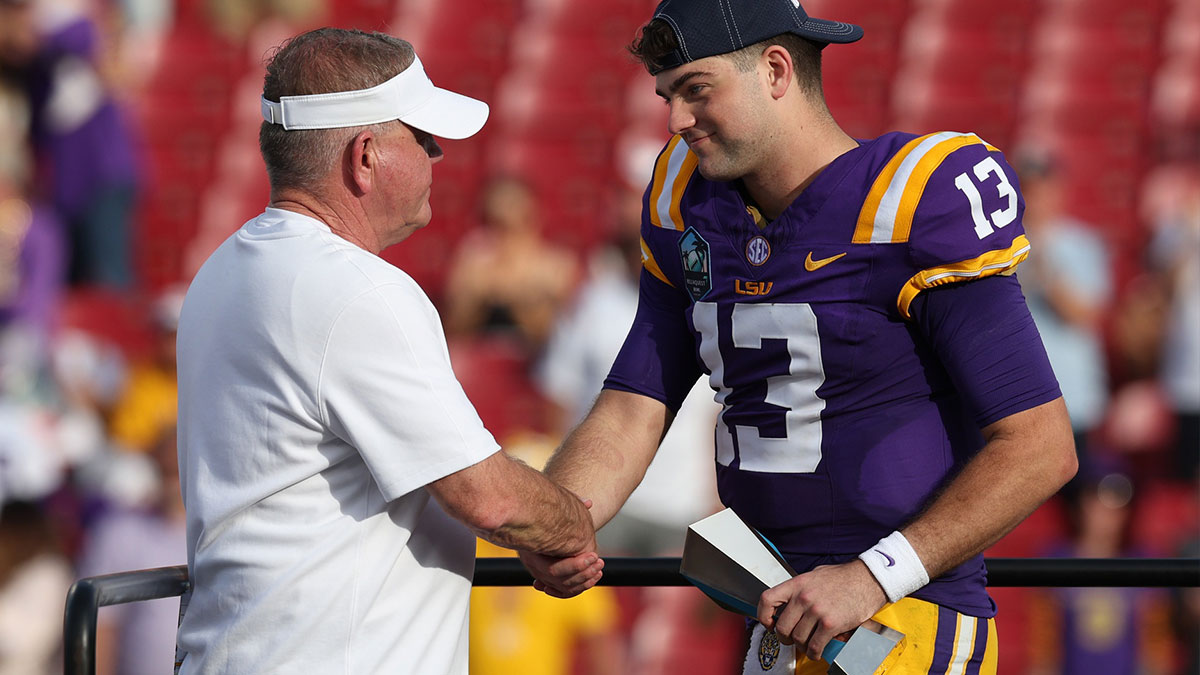 LSU Tigers quarterback Garrett Nussmeier (13) is congratulated by head coach Brian Kelly after being awarded the MVP award after beating the Wisconsin Badgers in the ReliaQuest Bowl at Raymond James Stadium.