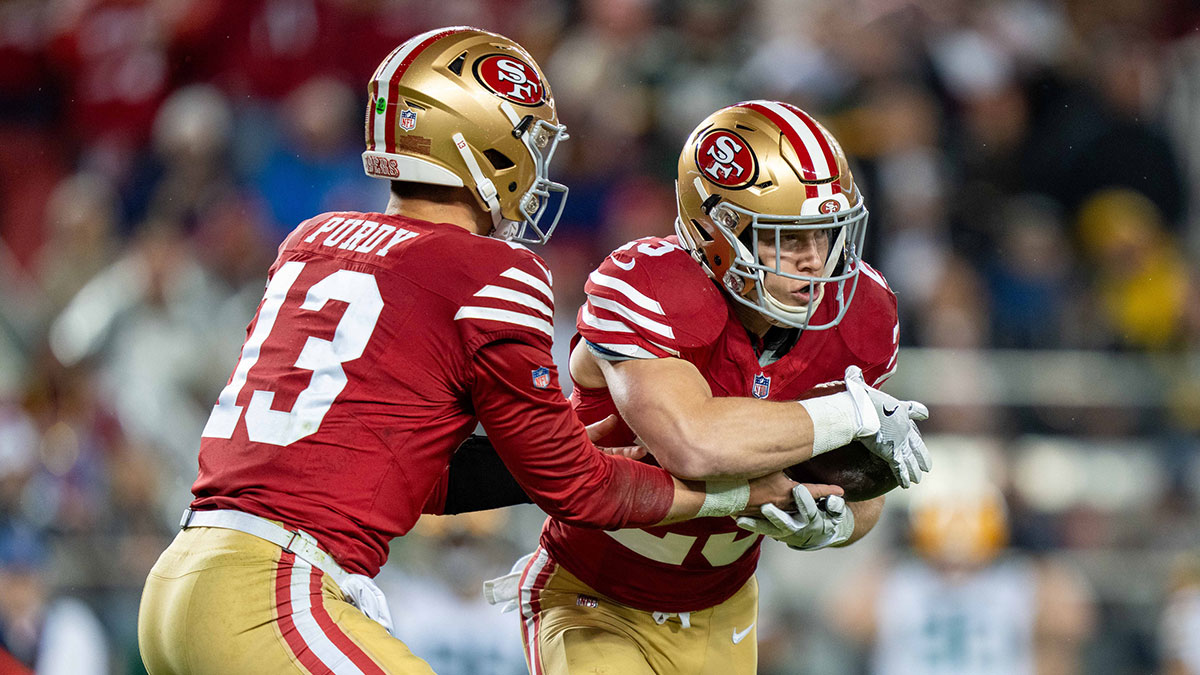 San Francisco 49ers running back Christian McCaffrey (23) receives the hand off from quarterback Brock Purdy (13) during the second quarter in a 2024 NFC divisional round game against the Green Bay Packers at Levi's Stadium.