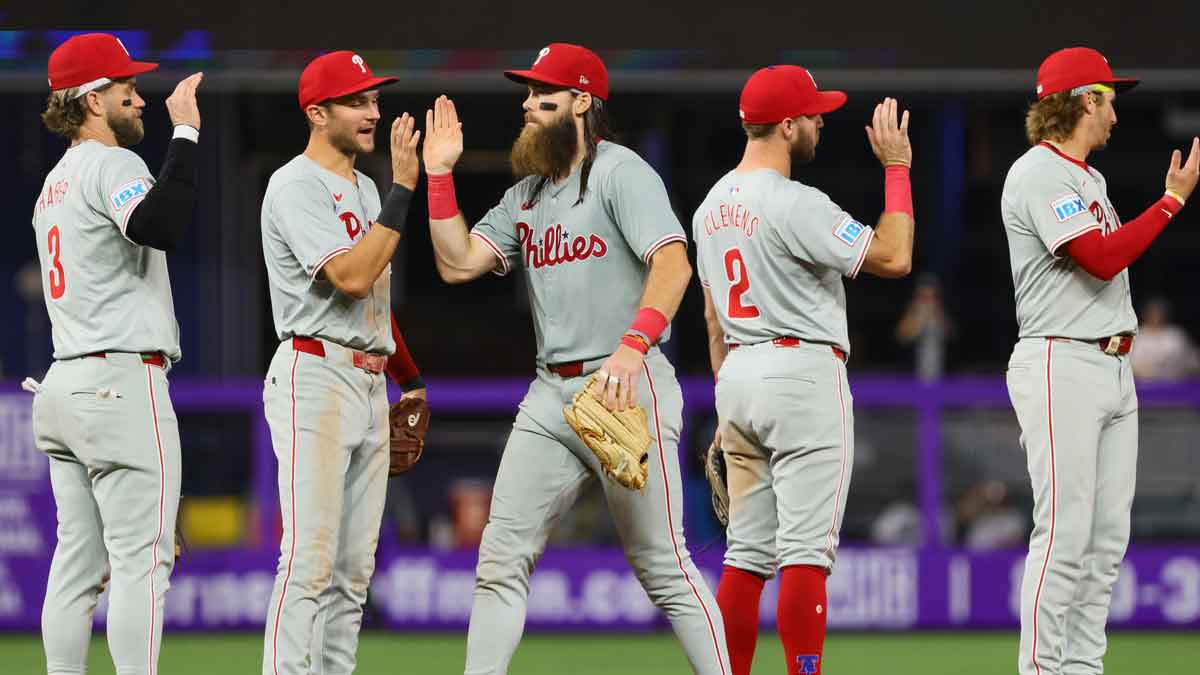 Sep 5, 2024; Miami, Florida, USA; Philadelphia Phillies first baseman Bryce Harper (3), shortstop Trea Turner (7), left fielder Brandon Marsh (16), third baseman Kody Clemens (2), and second baseman Bryson Stott (5) celebrate after the game against the Miami Marlins at loanDepot Park. Mandatory Credit: Sam Navarro-Imagn Images