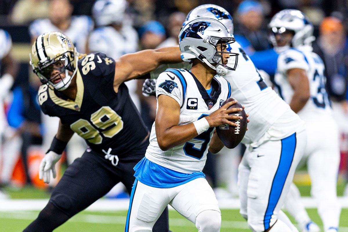 Carolina Panthers quarterback Bryce Young (9) scrambles to make a pass as New Orleans Saints defensive end Chase Young (99) rushes at him during the second half at Caesars Superdome.