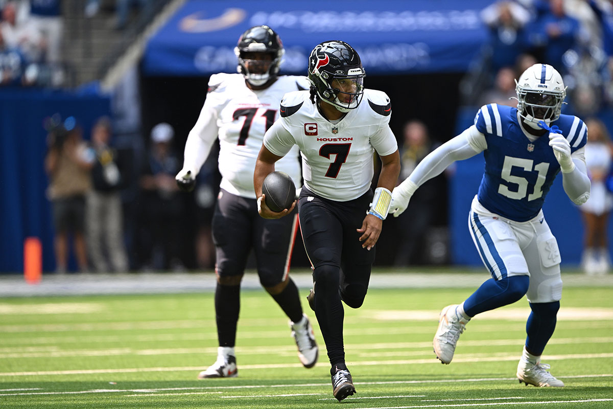 Houston Texans quarterback C.J. Stroud (7) runs away from Indianapolis Colts defensive end Kwity Paye (51) during the first quarter at Lucas Oil Stadium.