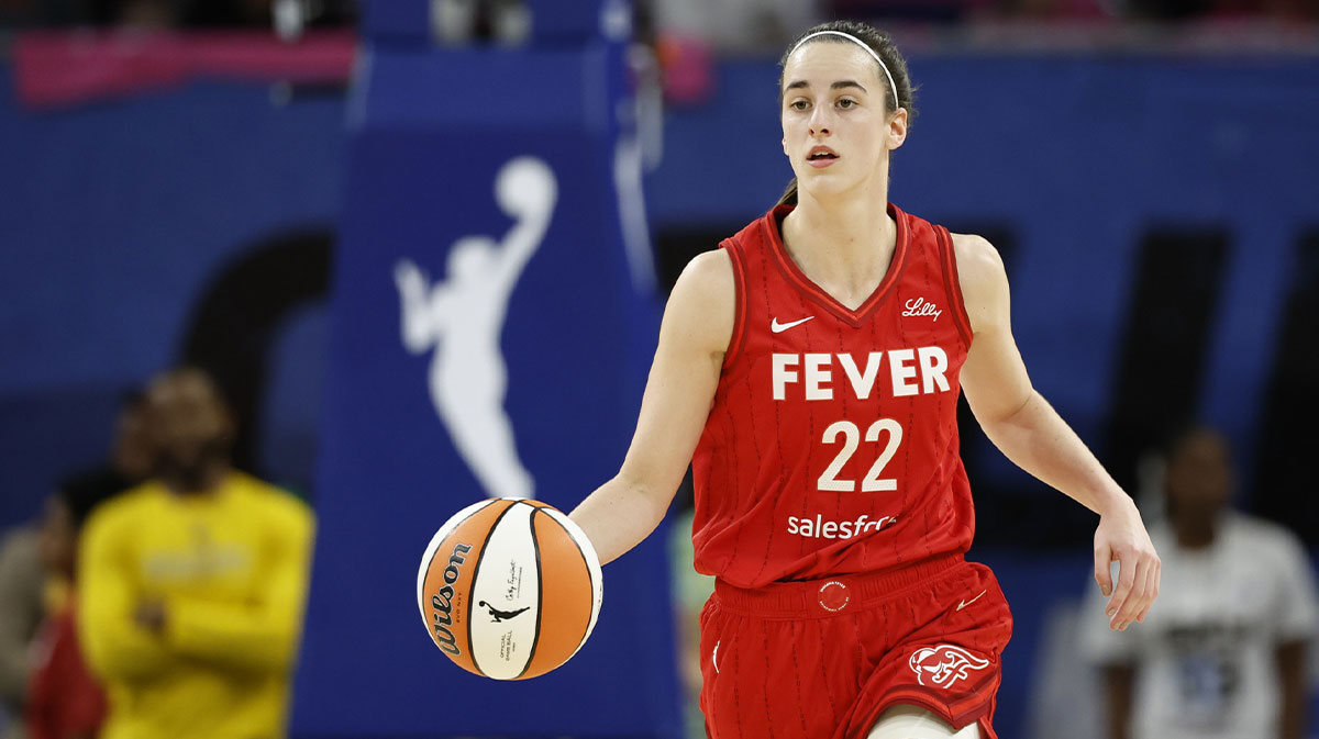 Indiana Fever guard Caitlin Clark (22) brings the ball up court against the Chicago Sky during the first half at Wintrust Arena.