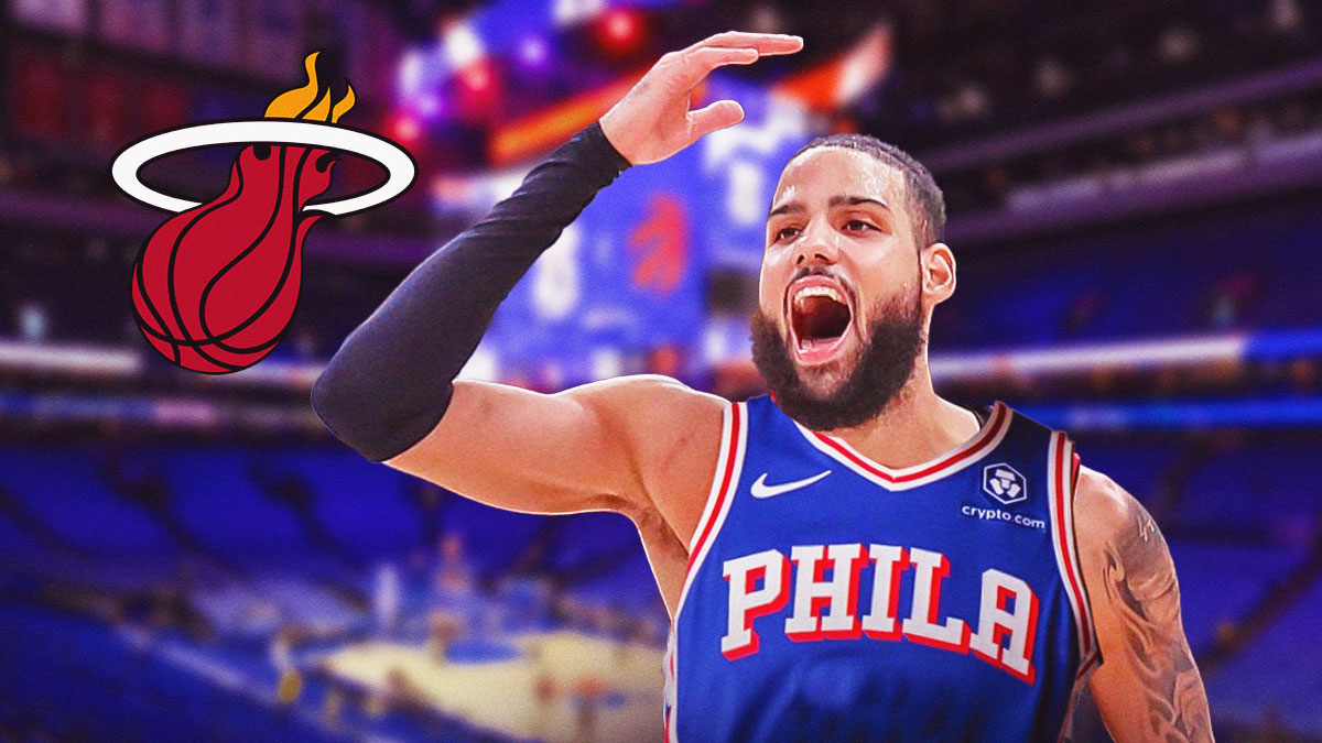 Caleb Martin wearing Sixer uniform waving goodbye at Miami Heat logo