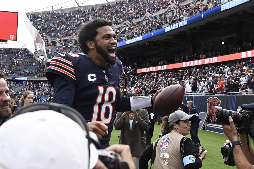 Chicago Bears quarterback Caleb Williams (18) greets fans after the second half against the Los Angeles Rams at Soldier Field.