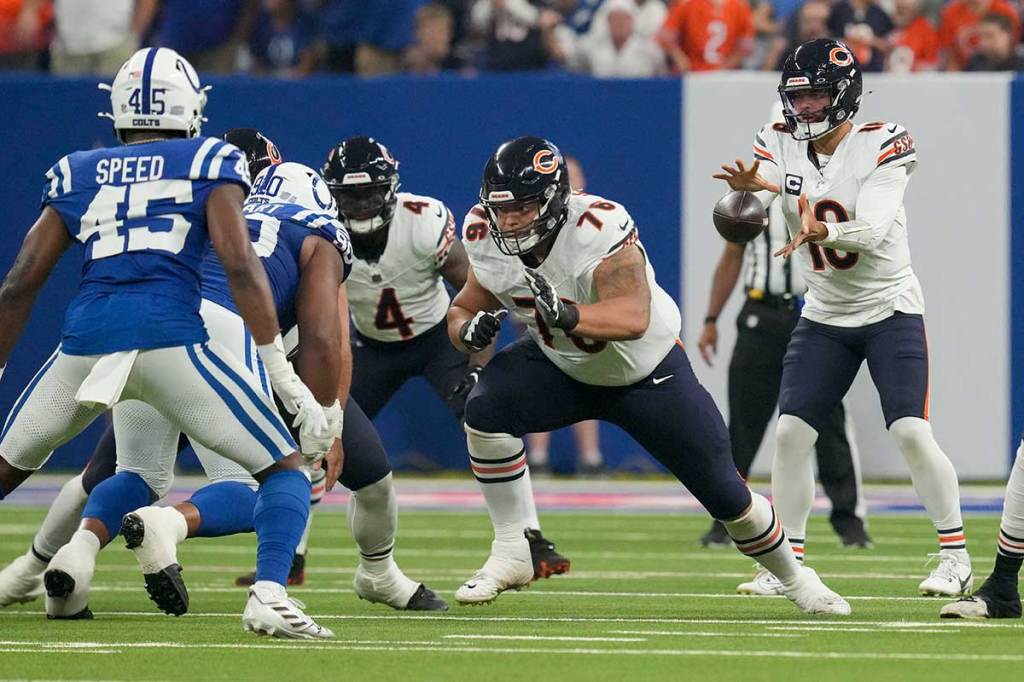 Chicago Bears quarterback Caleb Williams (18) reaches for the snap during a game against the Indianapolis Colts at Lucas Oil Stadium.