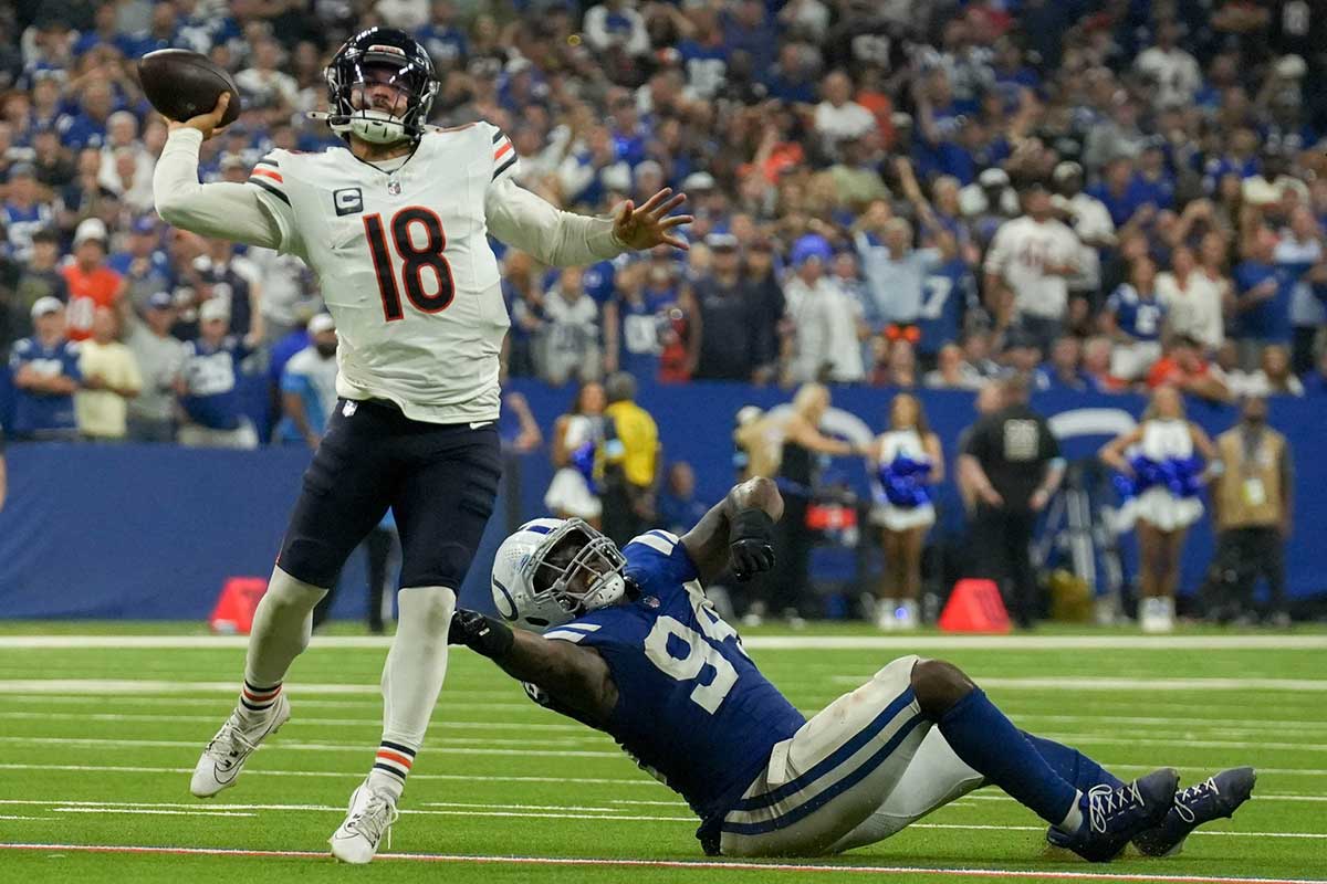 Indianapolis Colts defensive end Tyquan Lewis (94) tries to tackle Chicago Bears quarterback Caleb Williams (18) on Sunday, Sept. 22, 2024, during a game against the Chicago Bears