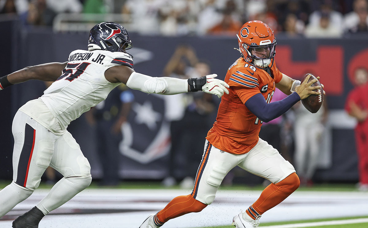 Sep 15, 2024; Houston, Texas, USA; Chicago Bears quarterback Caleb Williams (18) attempts to evade the tackle of Houston Texans defensive end Will Anderson Jr. (51) during the third quarter at NRG Stadium.