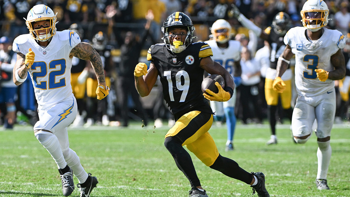 Pittsburgh Steelers wide receiver Calvin Austin III (19) scores a touchdown while being chased by Los Angeles Chargers cornerback Elijah Molden (22) during the fourth quarter at Acrisure Stadium.