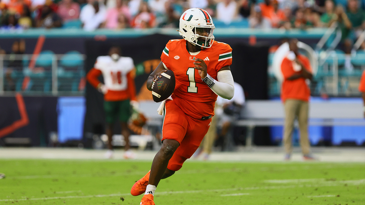 Miami Hurricanes quarterback Cam Ward (1) runs with the football against the Florida A&M Rattlers during the second quarter at Hard Rock Stadium.
