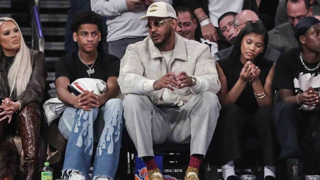 Former NBA player Carmelo Anthony (r) sits with his son Kiyan Anthony (l) at the game between the Boston Celtics and the New York Knicks at Madison Square Garden.