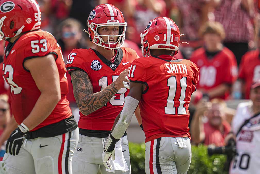 Georgia Bulldogs wide receiver Arian Smith (11) reacts with quarterback Carson Beck (15) after they combined on a touchdown pass against the Tennessee Tech Golden Eagles during the second half at Sanford Stadium. 