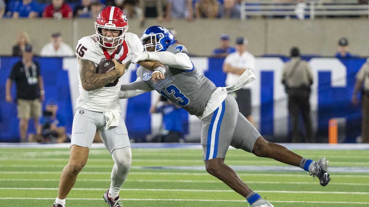 Kentucky Wildcats linebacker J.J. Weaver (13) attempts to sack Georgia Bulldogs quarterback Carson Beck (15) during the fourth quarter at Kroger Field.