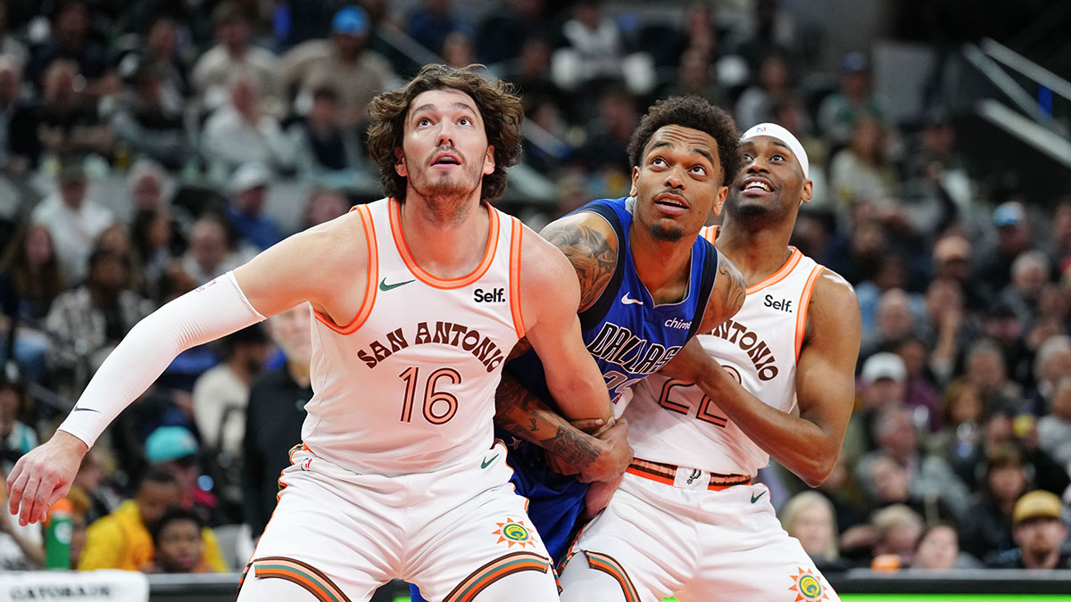 San Antonio Spurs forward Cedi Osman (16) and guard Malaki Branham (22) battle Dallas Mavericks forward PJ Washington (25) for position in the second half at Frost Bank Center. 