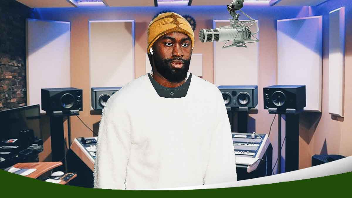 Celtics' Jaylen Brown in street clothes in front of a professional microphone, wearing a Hapbee around his neck, in a music studio filled with smoke in the background