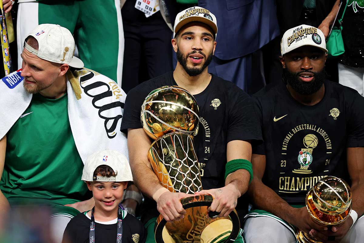 Celtics forward Jayson Tatum (0) and guard Jaylen Brown (7) celebrates with the Larry O’Brian Trophy after beating the Dallas Mavericks in game five of the 2024 NBA Finals to win the NBA Championship at TD Garden