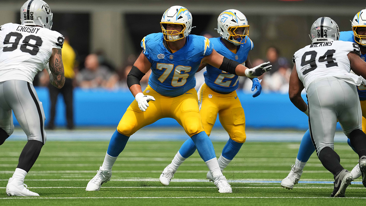 Los Angeles Chargers offensive tackle Joe Alt (76) defends against Las Vegas Raiders defensive end Maxx Crosby (98) and defensive tackle Christian Wilkins (94) in the first half at SoFi Stadium.